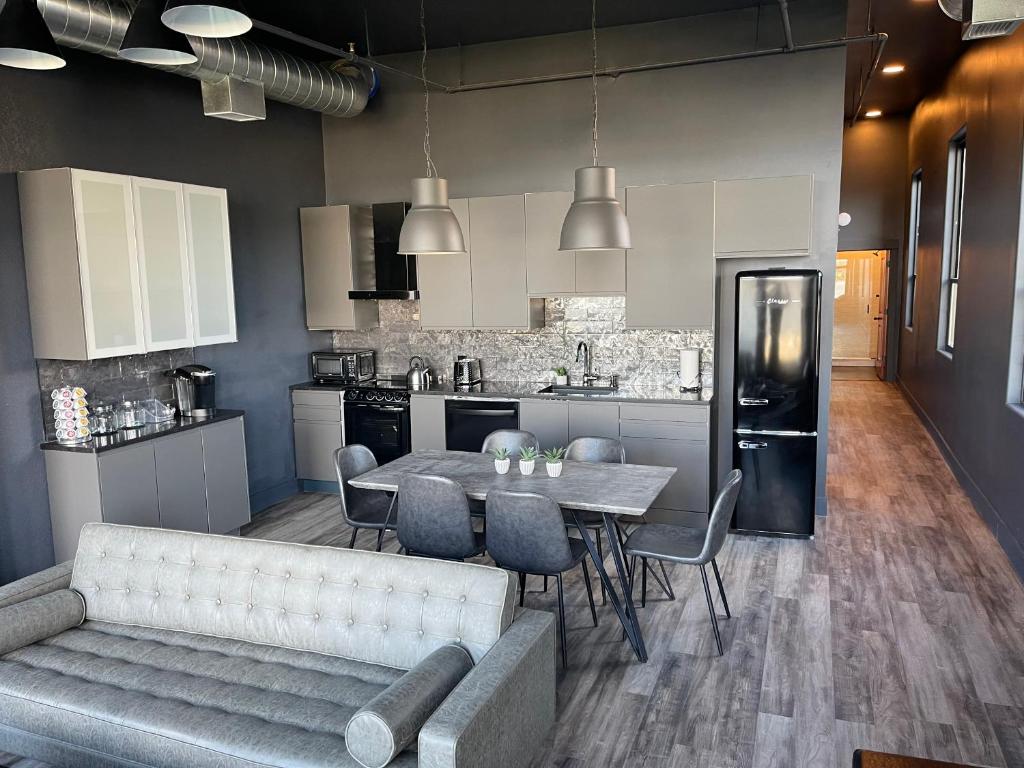 a kitchen and dining room with a table and a couch at City Loft Escape with River Views! By Hollyhock in Louisville