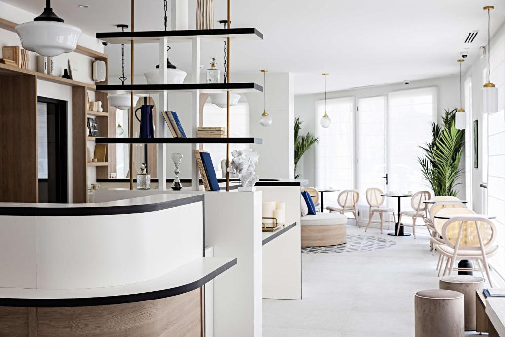 a kitchen and living room with a table and chairs at Le Riviera Collection, Signature Collection by Best Western in Nice