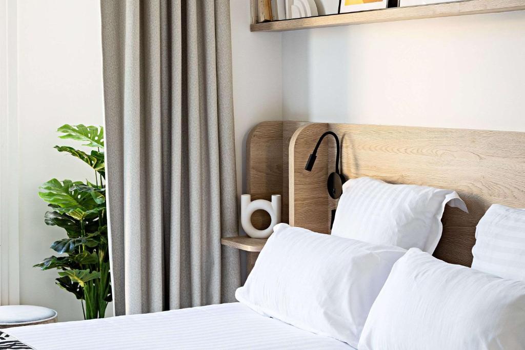 a bedroom with a bed with white pillows at Le Riviera Collection, Signature Collection by Best Western in Nice