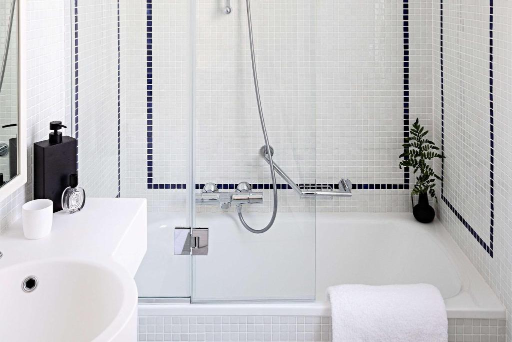 a bathroom with a shower and a sink and a tub at Le Riviera Collection, Signature Collection by Best Western in Nice