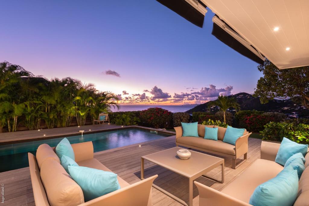 a villa with a swimming pool and a patio at Villa King Gustaf in Gustavia