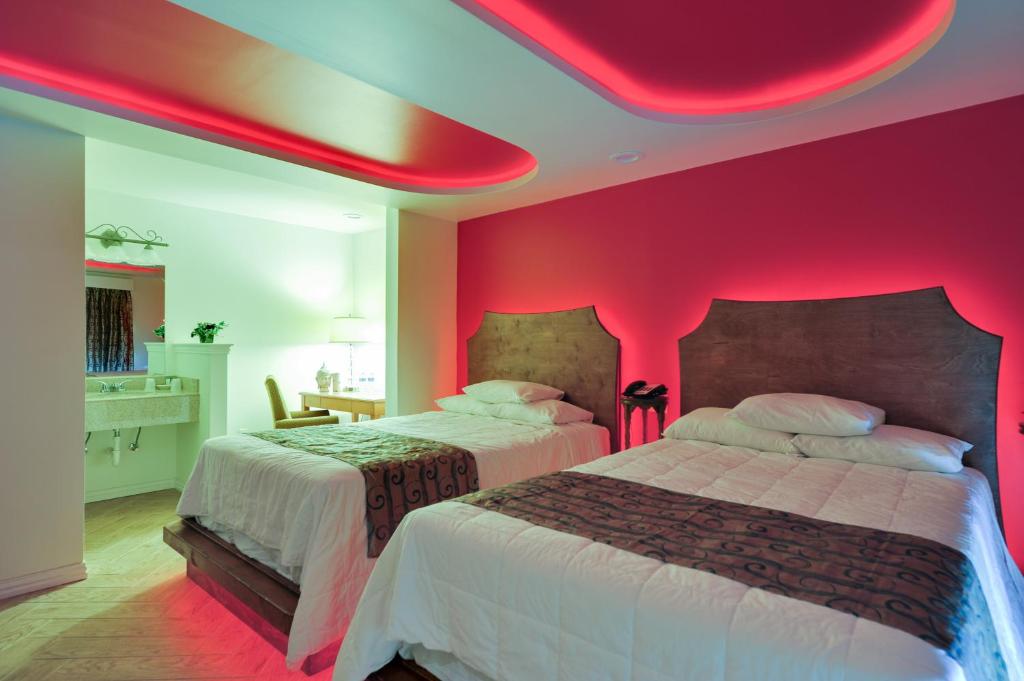 Postel nebo postele na pokoji v ubytování Romantic Inn & Suites