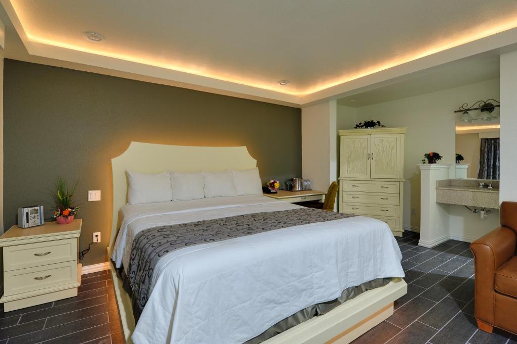 Postel nebo postele na pokoji v ubytování Romantic Inn & Suites