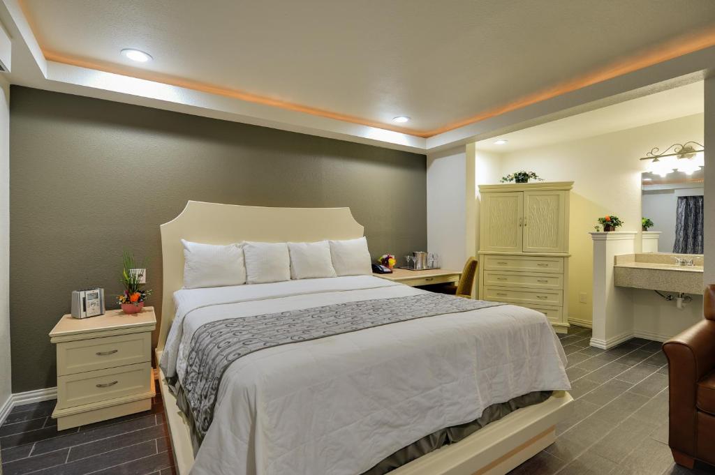 Postel nebo postele na pokoji v ubytování Romantic Inn & Suites