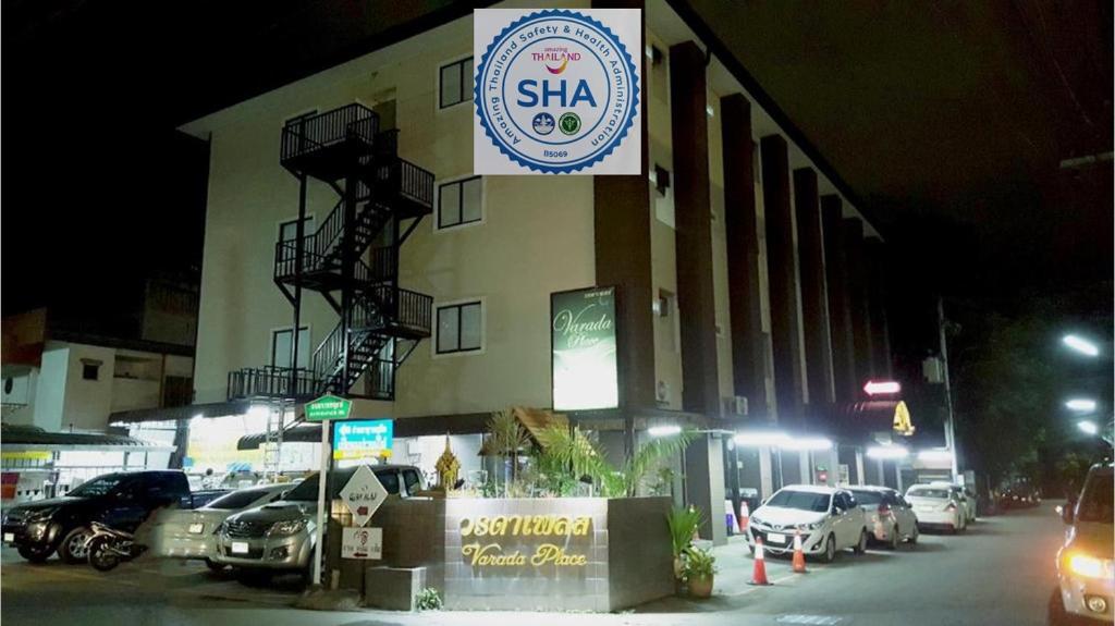 a building with a sign on the side of it at Varada Place in Chiang Mai