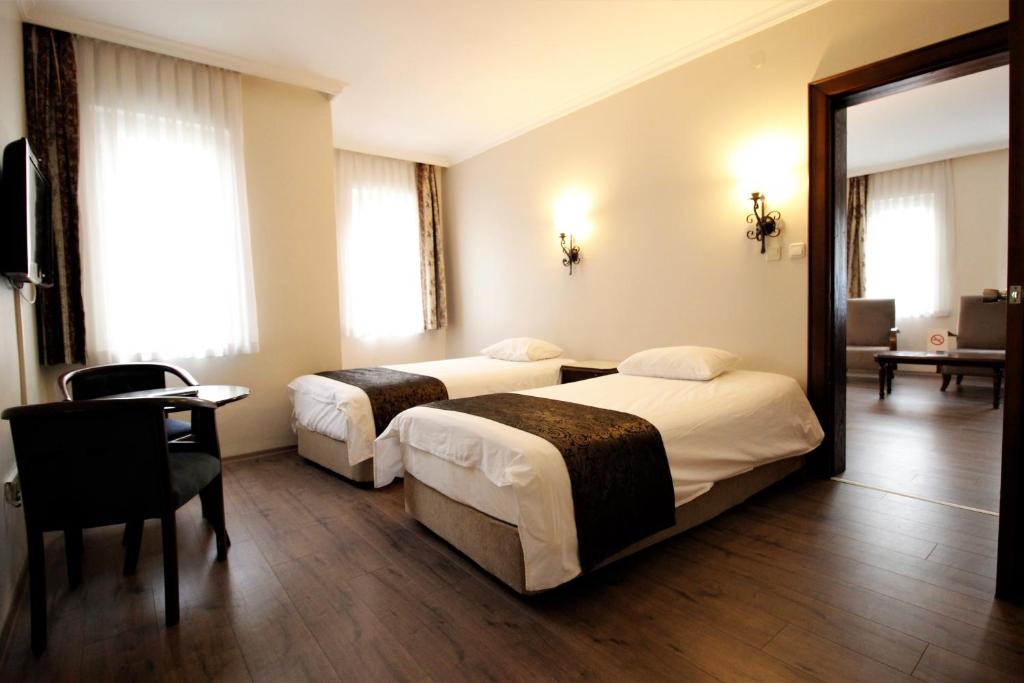 Postel nebo postele na pokoji v ubytování Montania Town Hotel Mudanya