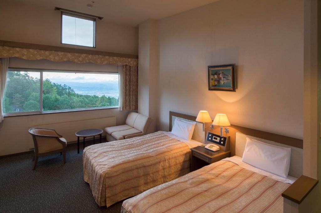 Postel nebo postele na pokoji v ubytování Izumigo AMBIENT Azumino Hotel