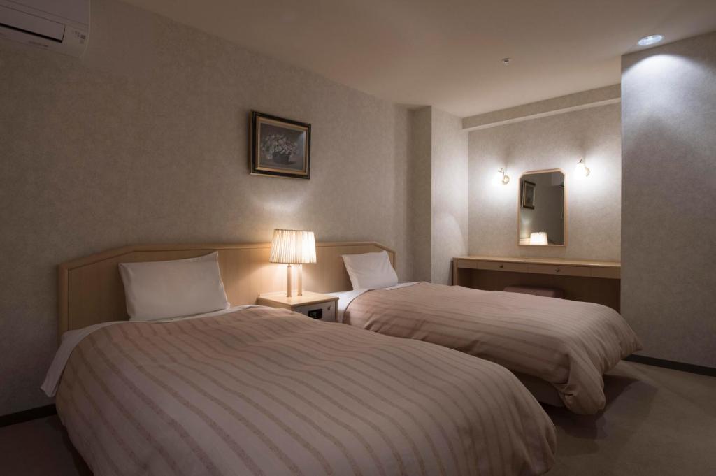 Postel nebo postele na pokoji v ubytování Izumigo AMBIENT Azumino Hotel