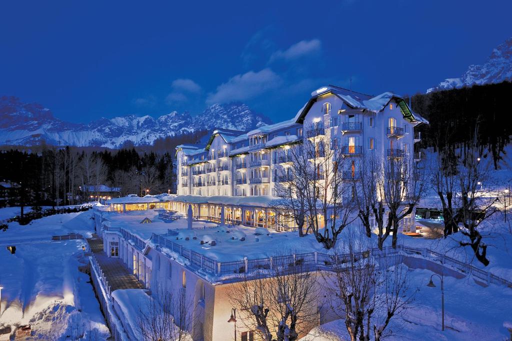 a large building with a lot of snow on top of it at Cristallo, a Luxury Collection Resort & Spa, Cortina D 'Ampezzo in Cortina dʼAmpezzo