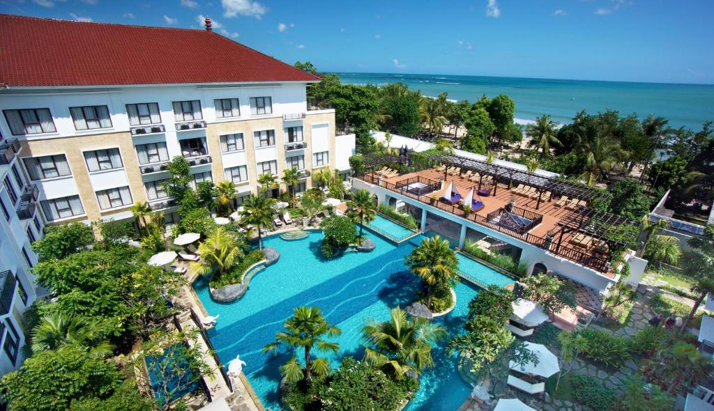 an aerial view of a resort with a swimming pool at Truntum Kuta Formerly Grand Inna Kuta in Kuta