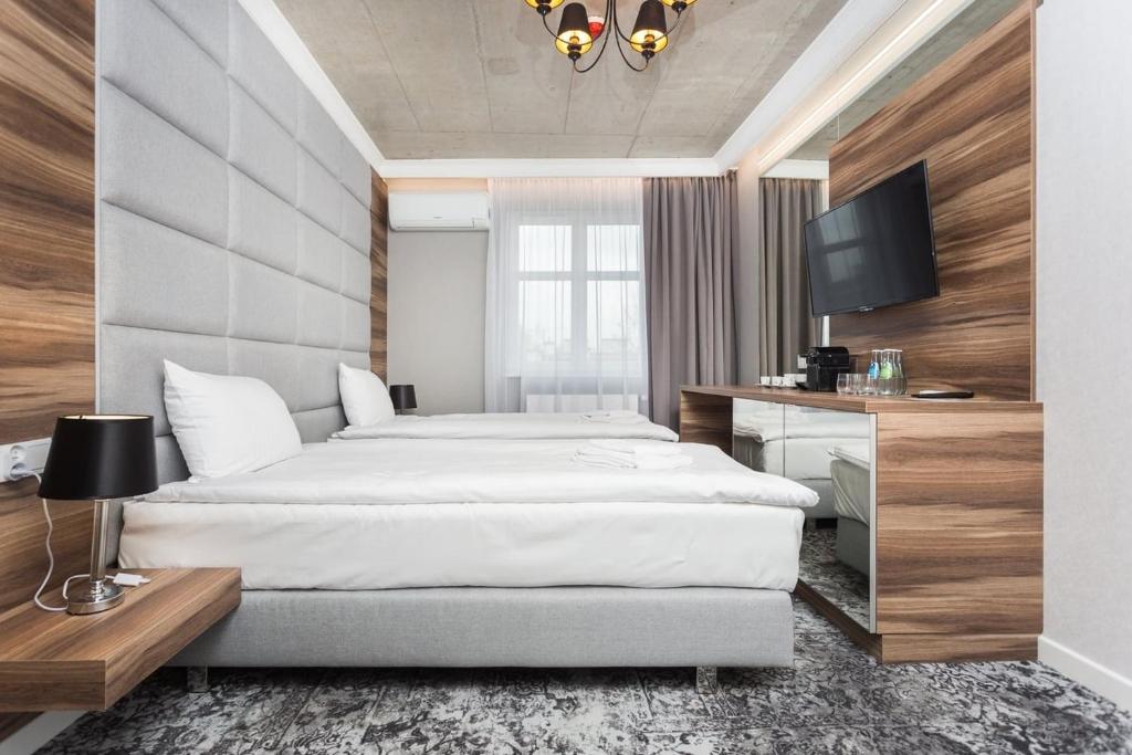 Posteľ alebo postele v izbe v ubytovaní Aparthotel Rakowicka Residence