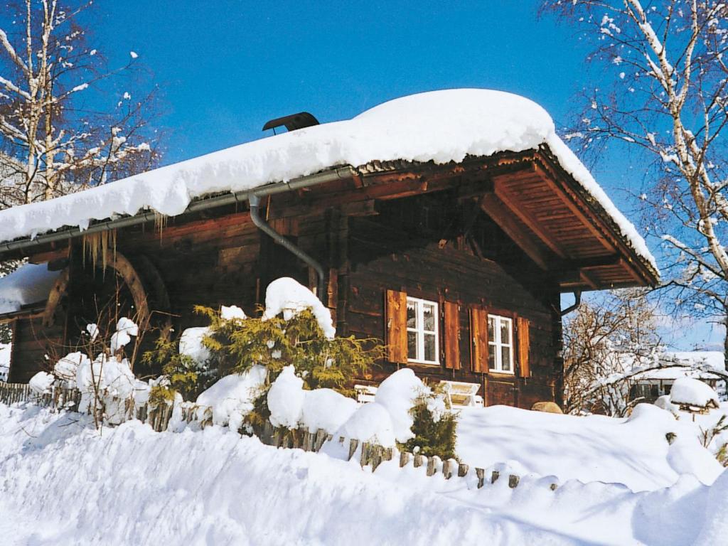 a log cabin with snow on the roof at Chalet Hüttl by Interhome in Trins