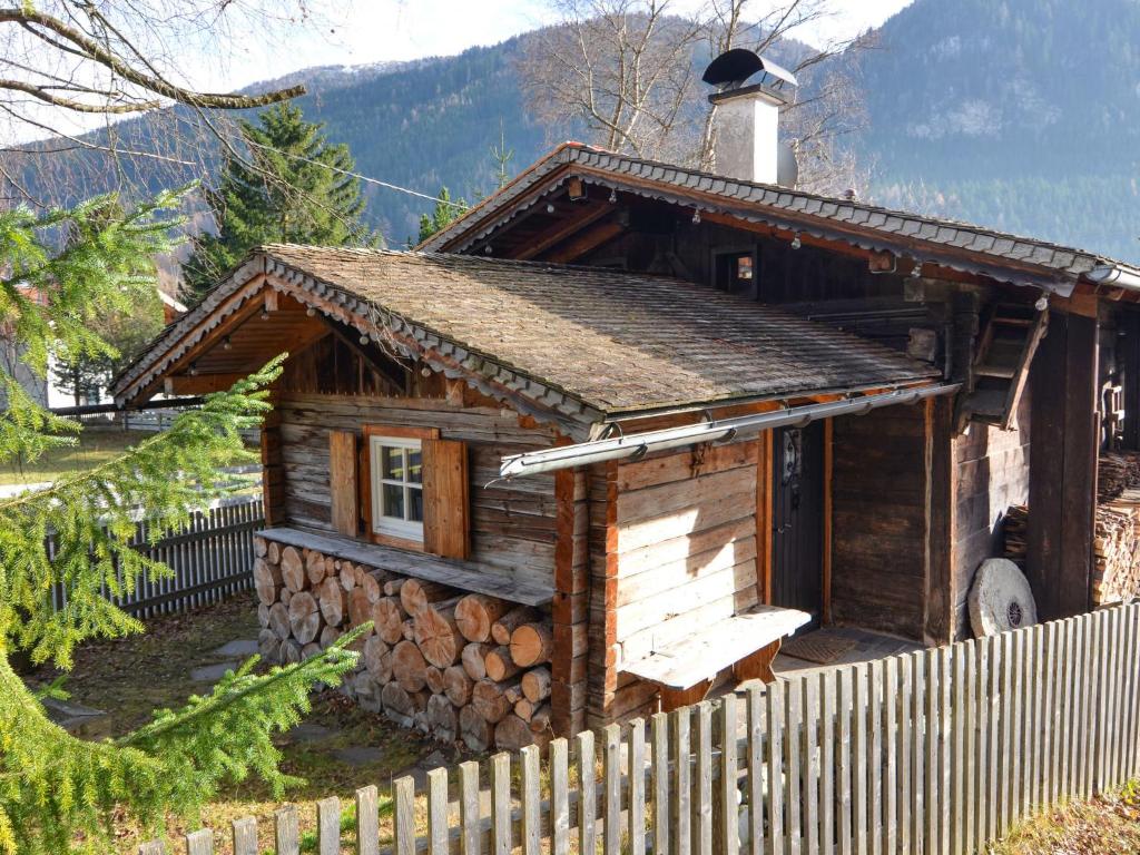 a log cabin with a fence in front of it at Chalet Hüttl by Interhome in Trins