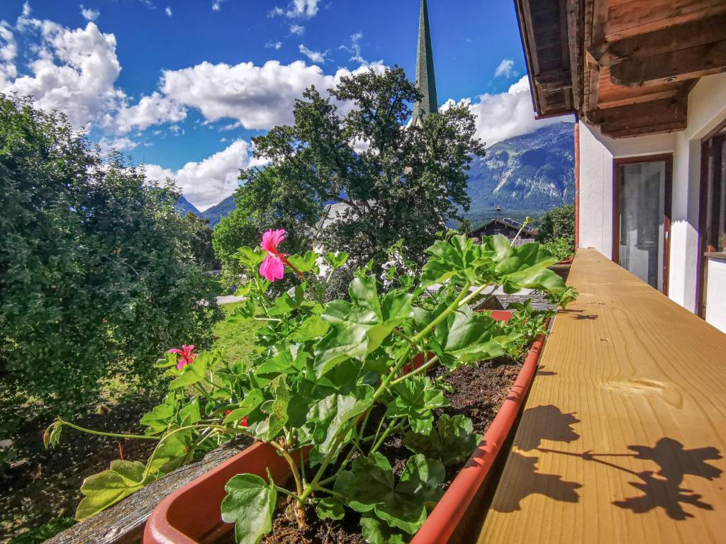 a balcony with flowers and a view of the mountains at Holiday Home Kainer - FGZ210 by Interhome in Strass im Zillertal