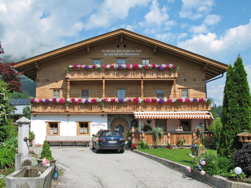 a building with a car parked in front of it at Apartment Punggerhof - KAB100 by Interhome in Kaltenbach