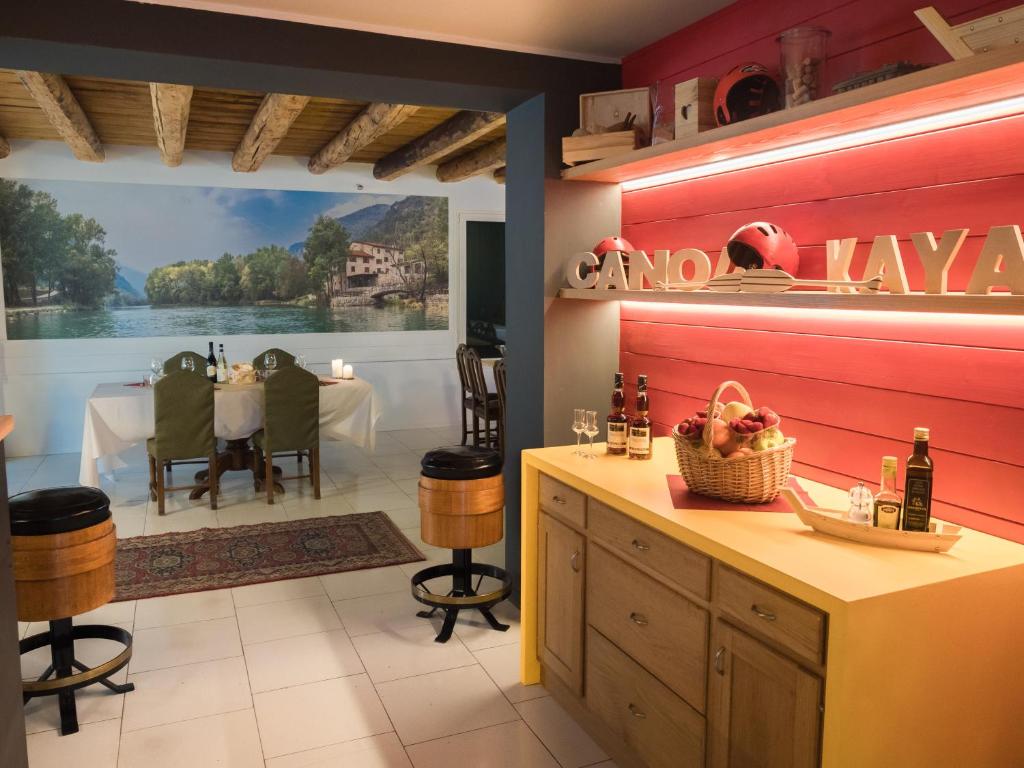 a dining room with a view of a dining table at Rafting Hotel Ai Cavallini in Solagna