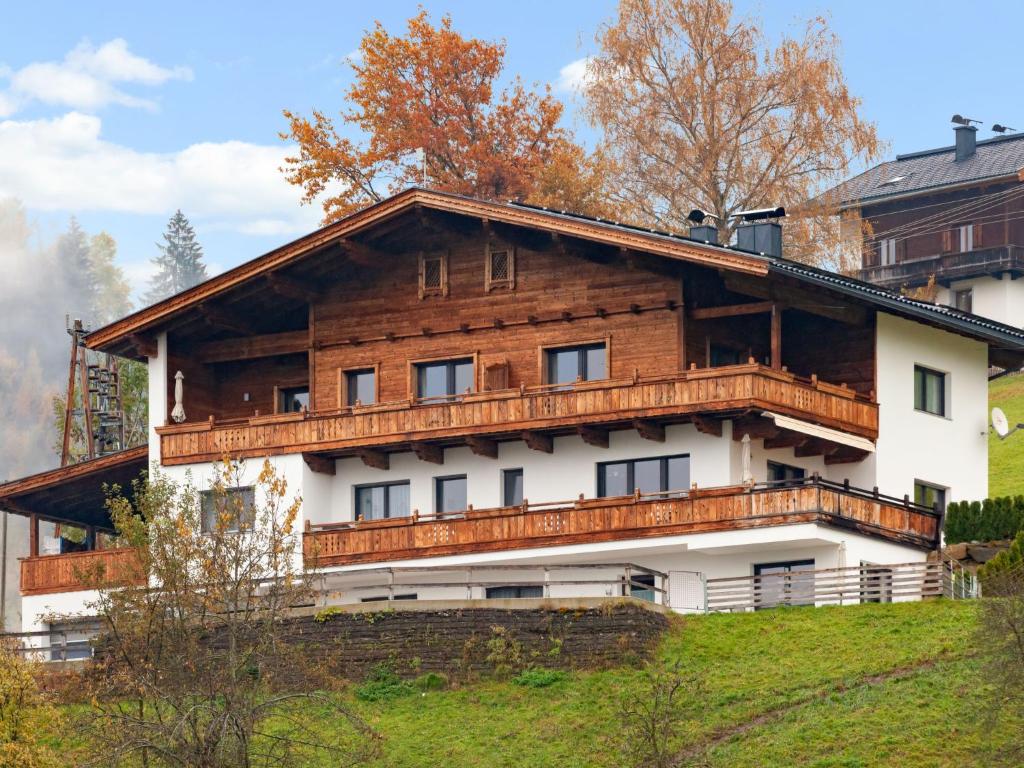 a large wooden house on top of a hill at Apartment Apart Wurm - SUZ380 by Interhome in Stummerberg