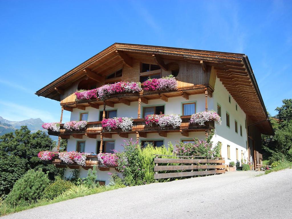 a house with flowers on the side of it at Apartment Ferienhaus Sonnseitn-2 by Interhome in Gattererberg