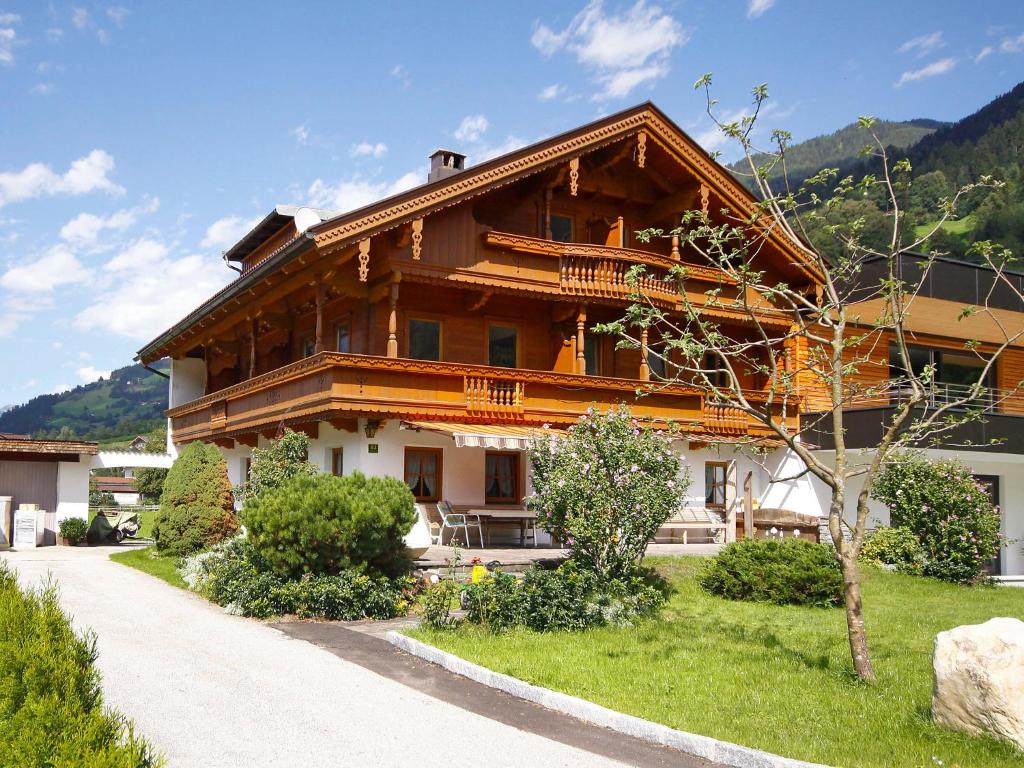 a large wooden house with a pathway in front of it at Holiday Home Hauser by Interhome in Mayrhofen