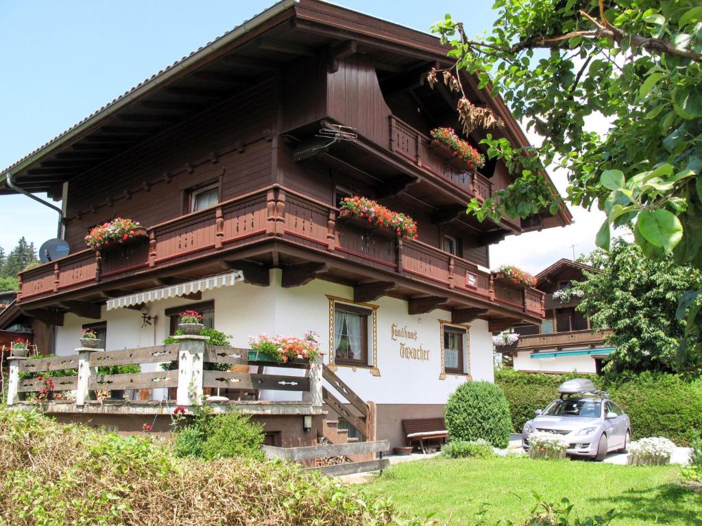 a house with flowers on the front of it at Apartment Taxacher - ZAZ765 by Interhome in Aschau