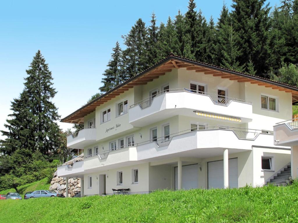 a large white building with trees in the background at Apartment Haus Huber - ZAZ404 by Interhome in Zell am Ziller