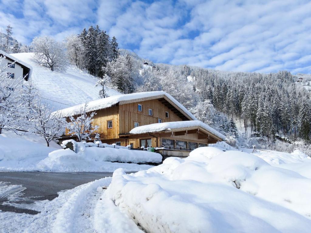 a house covered in snow next to a road at Chalet Talbach - MHO778 by Interhome in Laimach