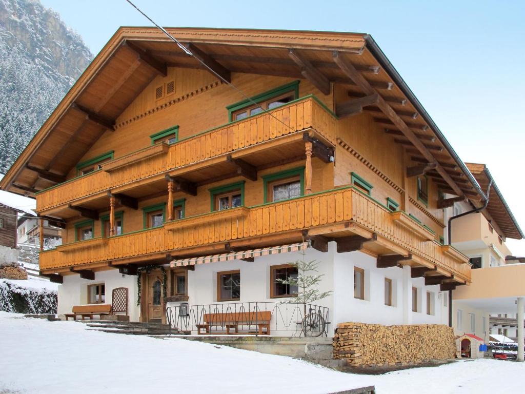 a large building with snow on the ground at Holiday Home Rieplerhof by Interhome in Mayrhofen