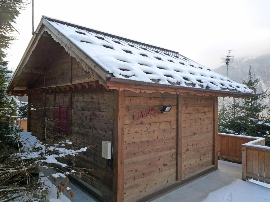 a wooden building with snow on the roof at Chalet Evasion by Interhome in Les Bossons