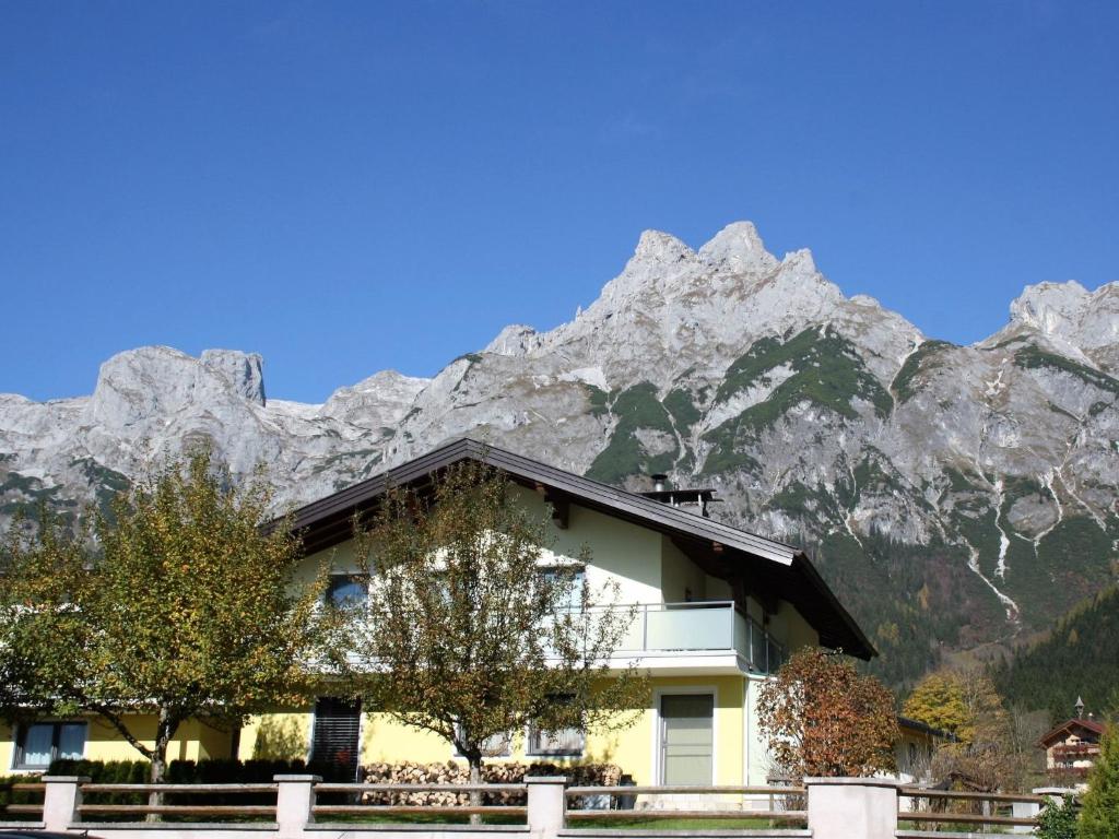 a building with a mountain in the background at Apartment Rosi-1 by Interhome in Werfenweng