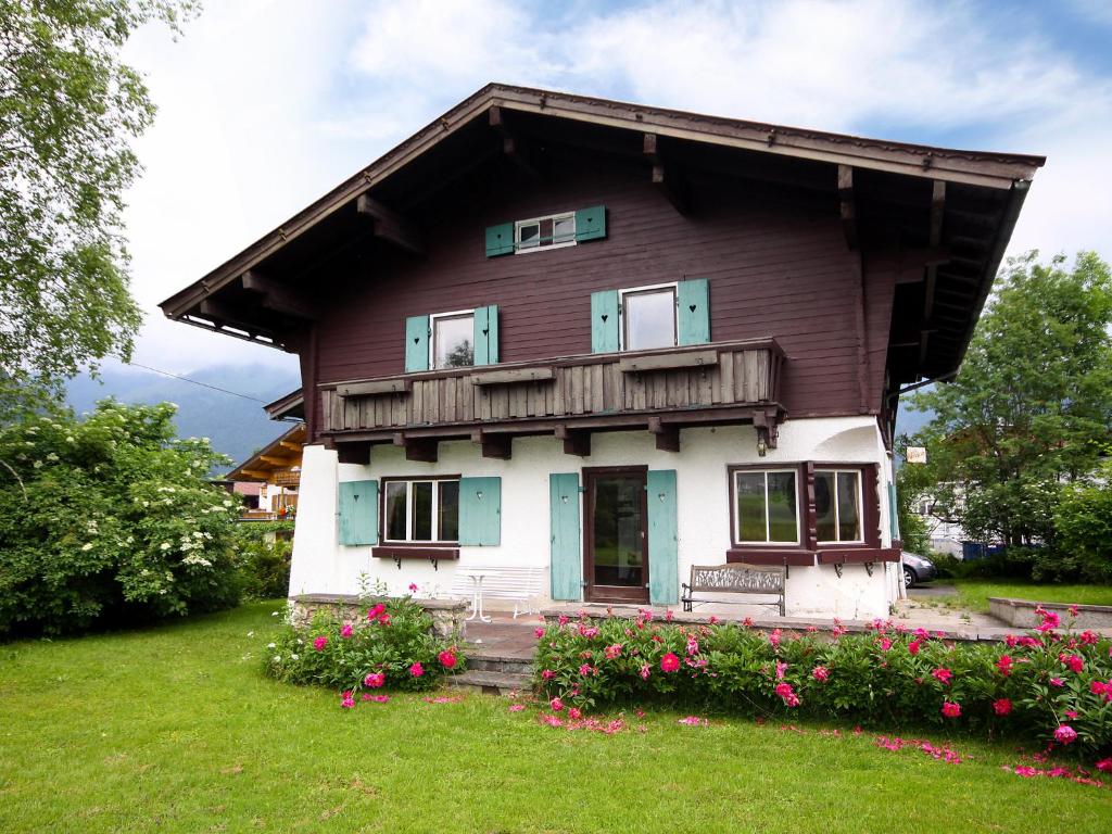 a house with flowers in front of it at Chalet Patricia by Interhome in Kössen