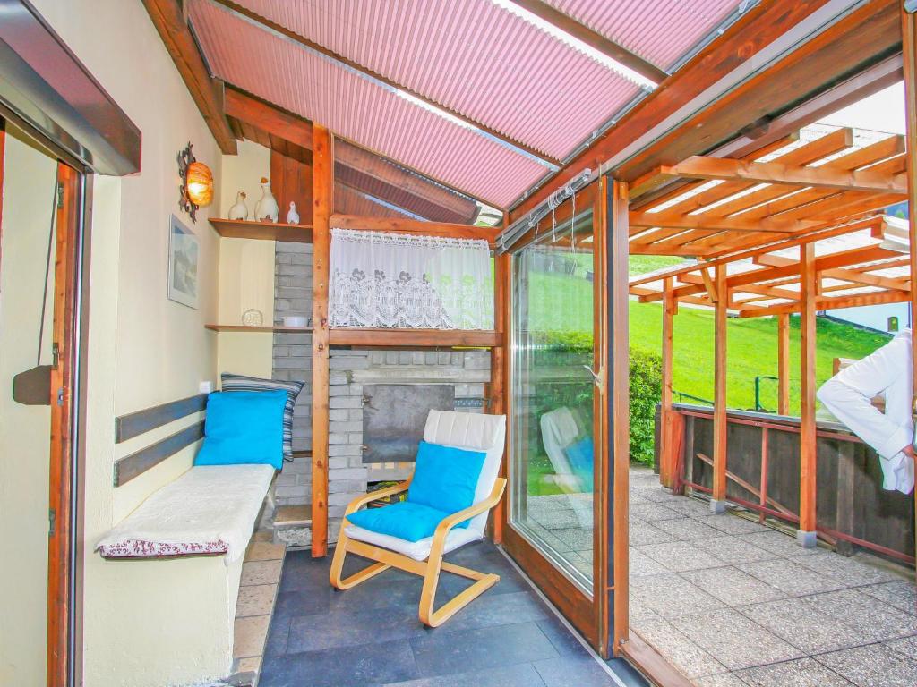 a screened in porch with two chairs and a couch at Holiday Home Haselwanter by Interhome in Sellrain