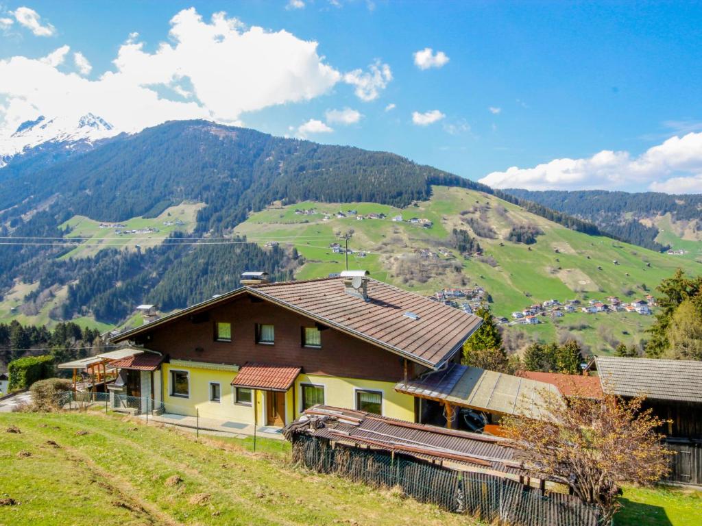 a house on a hill with mountains in the background at Holiday Home Haselwanter by Interhome in Sellrain