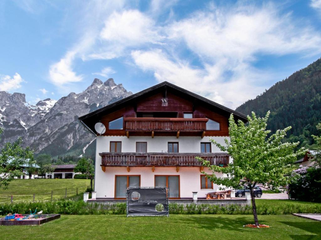 a house in the mountains with a tree at Apartment Edelweiss-1 by Interhome in Werfenweng