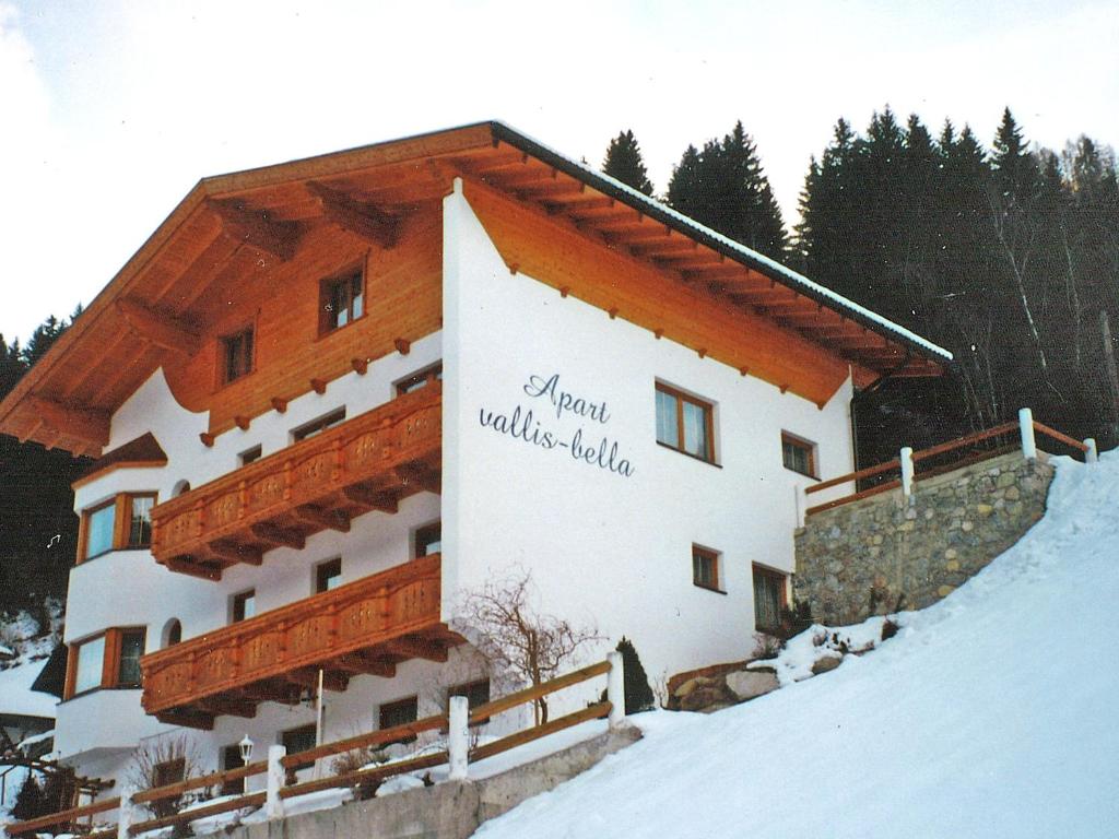 a building with a sign on the side of it in the snow at Apartment Vallis Bella by Interhome in Langesthei