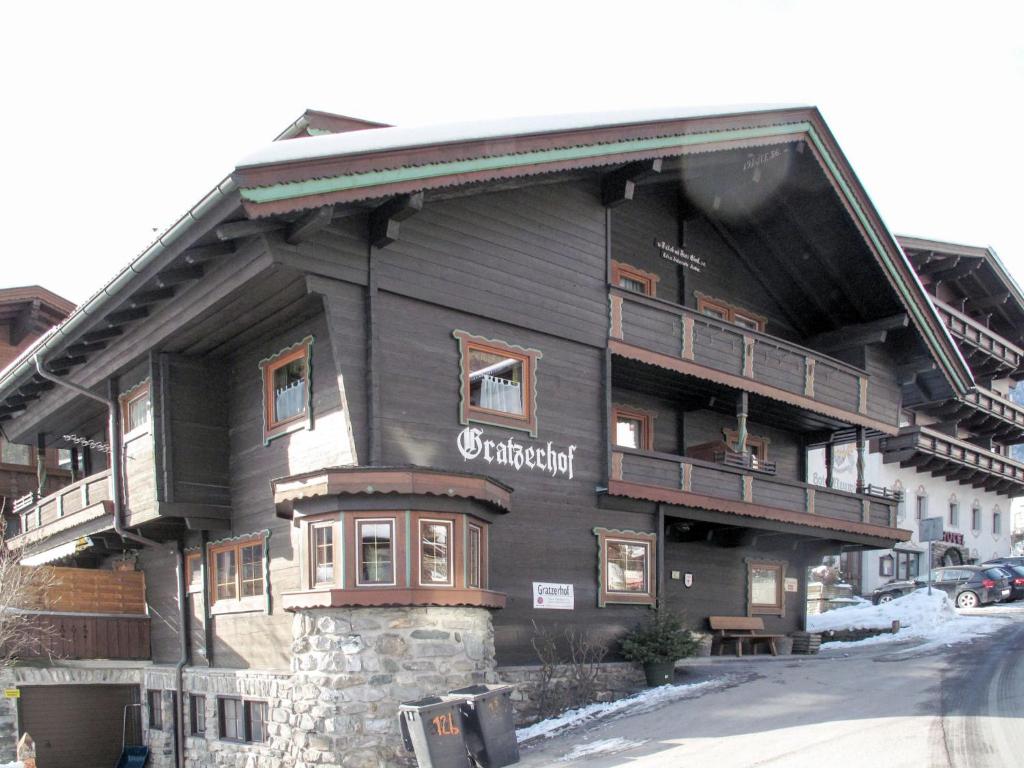 a large wooden building with a balcony on a street at Apartment Gratzerhof-2 by Interhome in Finkenberg