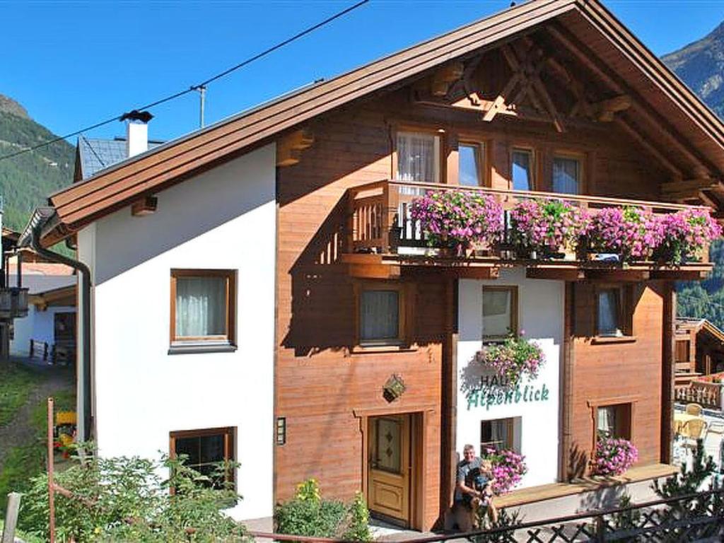 a house with a balcony with flowers on it at Apartment Alpenblick - SOE750 by Interhome in Sölden