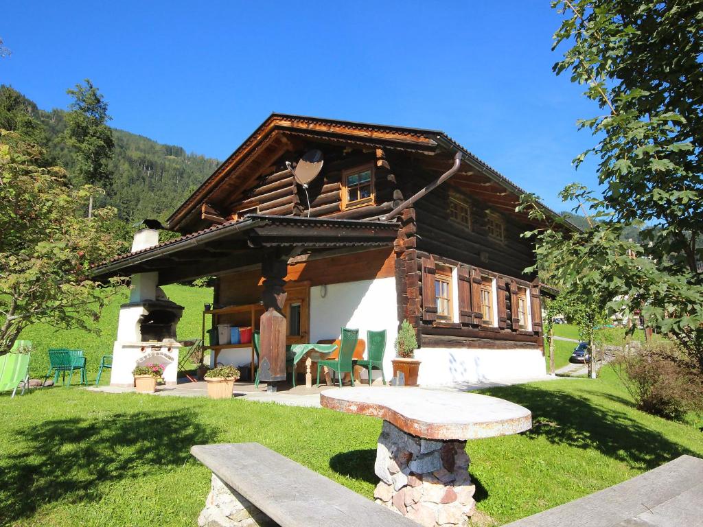 a log cabin with a bench in front of it at Chalet Auhäusl by Interhome in Fügenberg