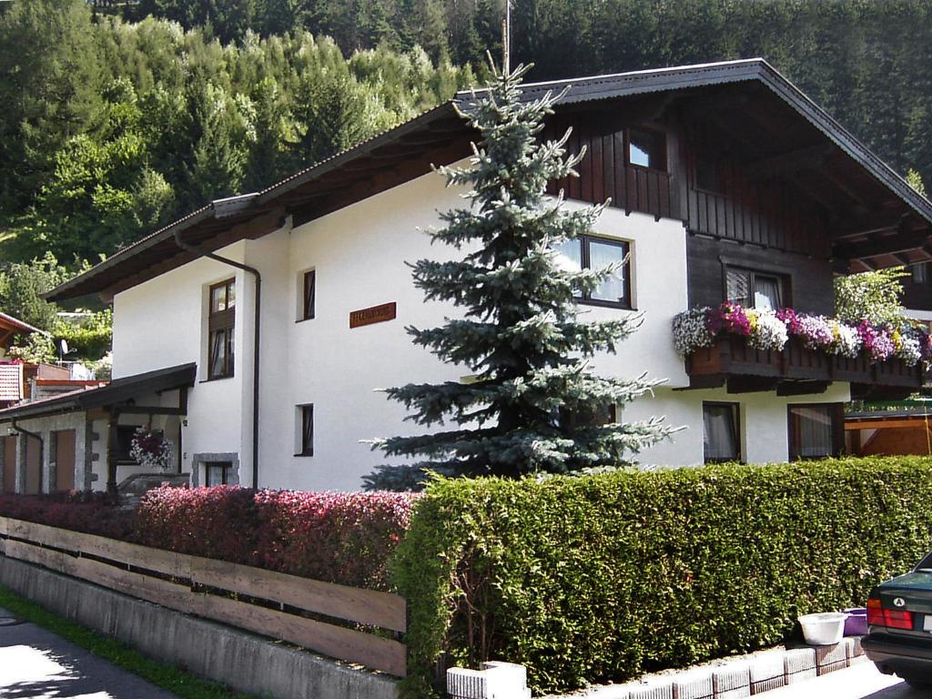 una casa con un árbol de Navidad delante de ella en Apartment Spörr by Interhome, en Matrei am Brenner