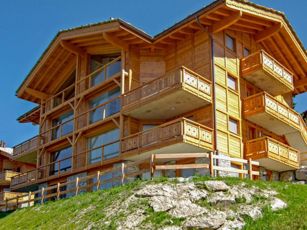 a large wooden building on top of a hill at Apartment La Corniche 2 by Interhome in Nendaz