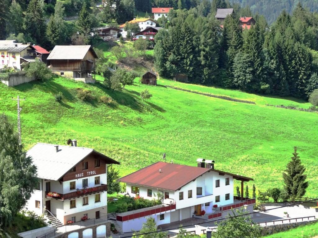 a small village with houses and a green field at Apartment Tyrol - TDL125 by Interhome in Tobadill