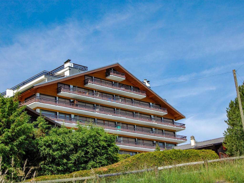 a large apartment building on top of a hill at Apartment Panoramic B1 by Interhome in Nendaz