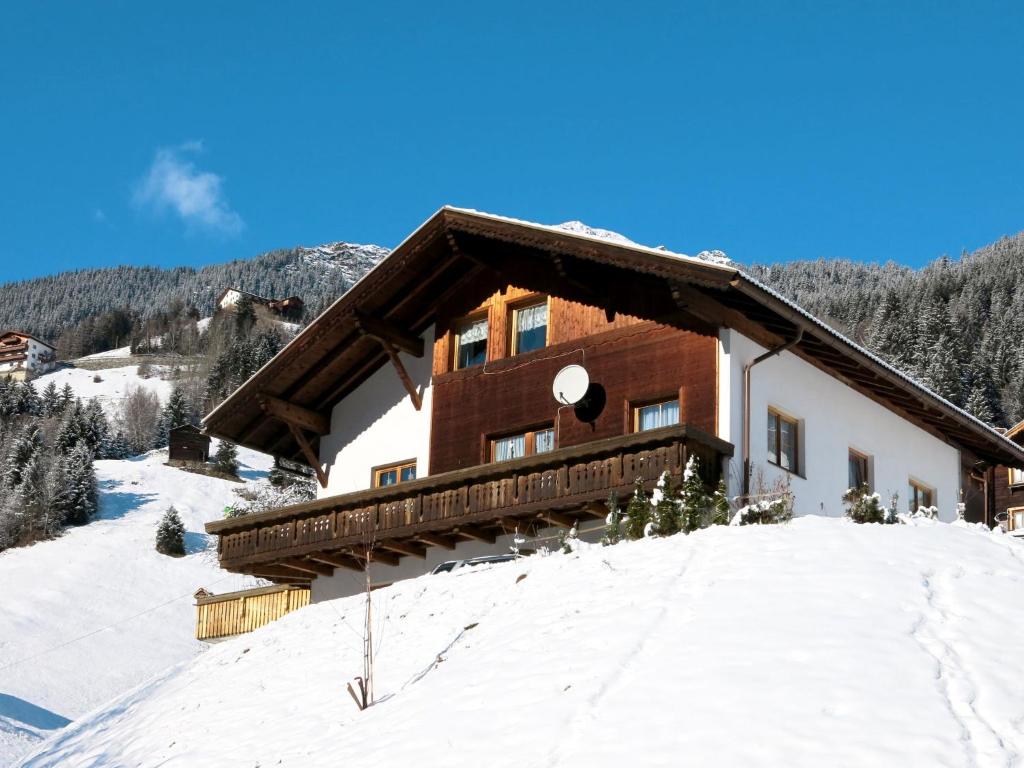 a house on a snowy hill with a balcony at Apartment Maria by Interhome in Kappl