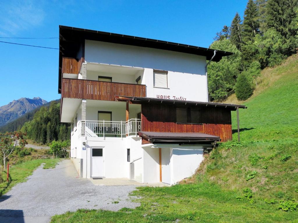 a white building with a balcony on a hill at Holiday Home Julia - KPL641 by Interhome in Kappl