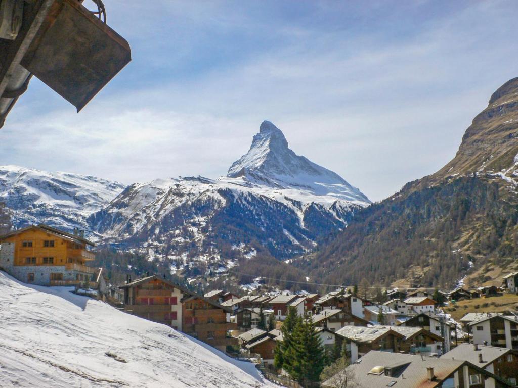 a mountain in the distance with a town and a mountain at Apartment Alba by Interhome in Zermatt