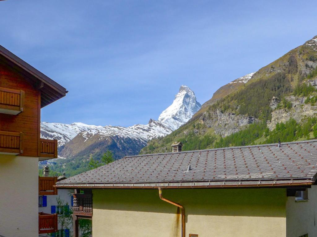 a view of a snow covered mountain with a building at Apartment Dianthus-1 by Interhome in Zermatt