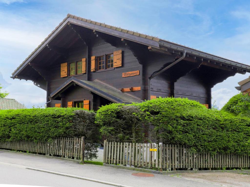 a house with a fence in front of it at Chalet Chalet Merymont by Interhome in Villars-sur-Ollon