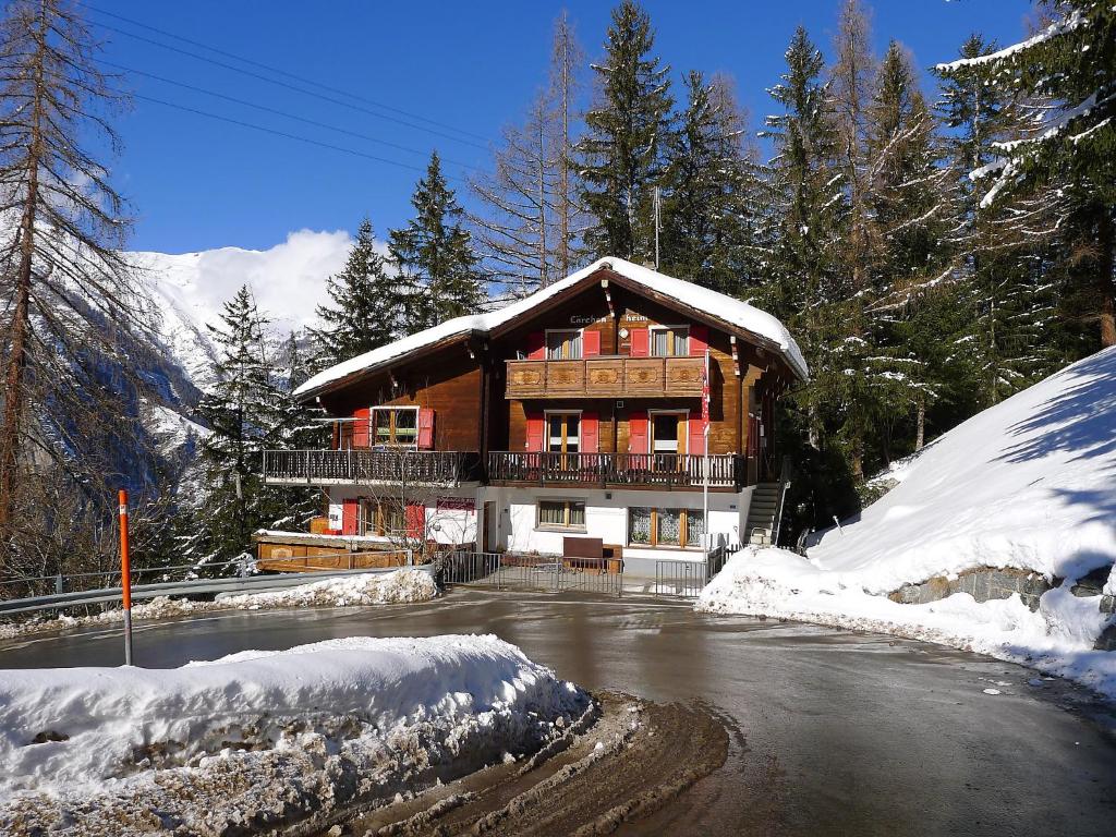 a large wooden house with snow on the ground at Apartment Lärchenheim by Interhome in Gasenried