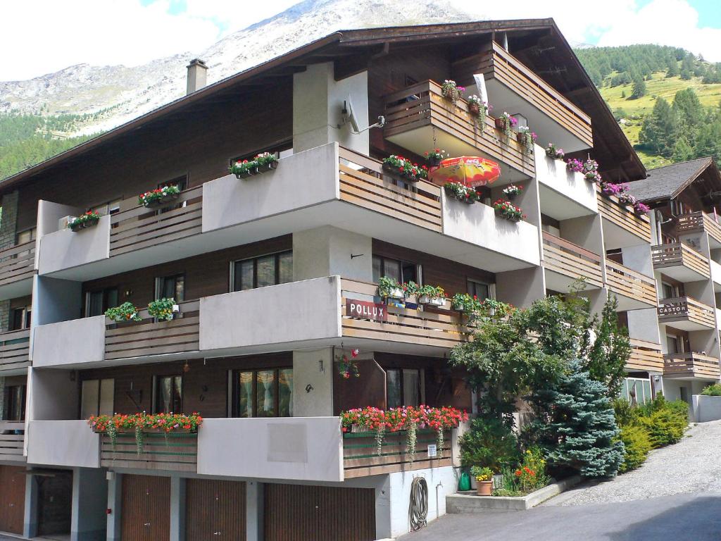 ein Apartmenthaus mit Blumenkästen auf den Balkonen in der Unterkunft Apartment Castor und Pollux-1 by Interhome in Täsch