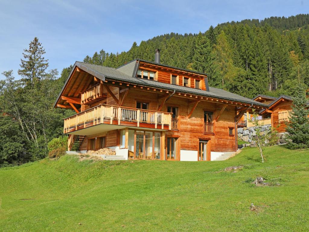 a large wooden house on top of a hill at Chalet Khamariah by Interhome in Villars-sur-Ollon