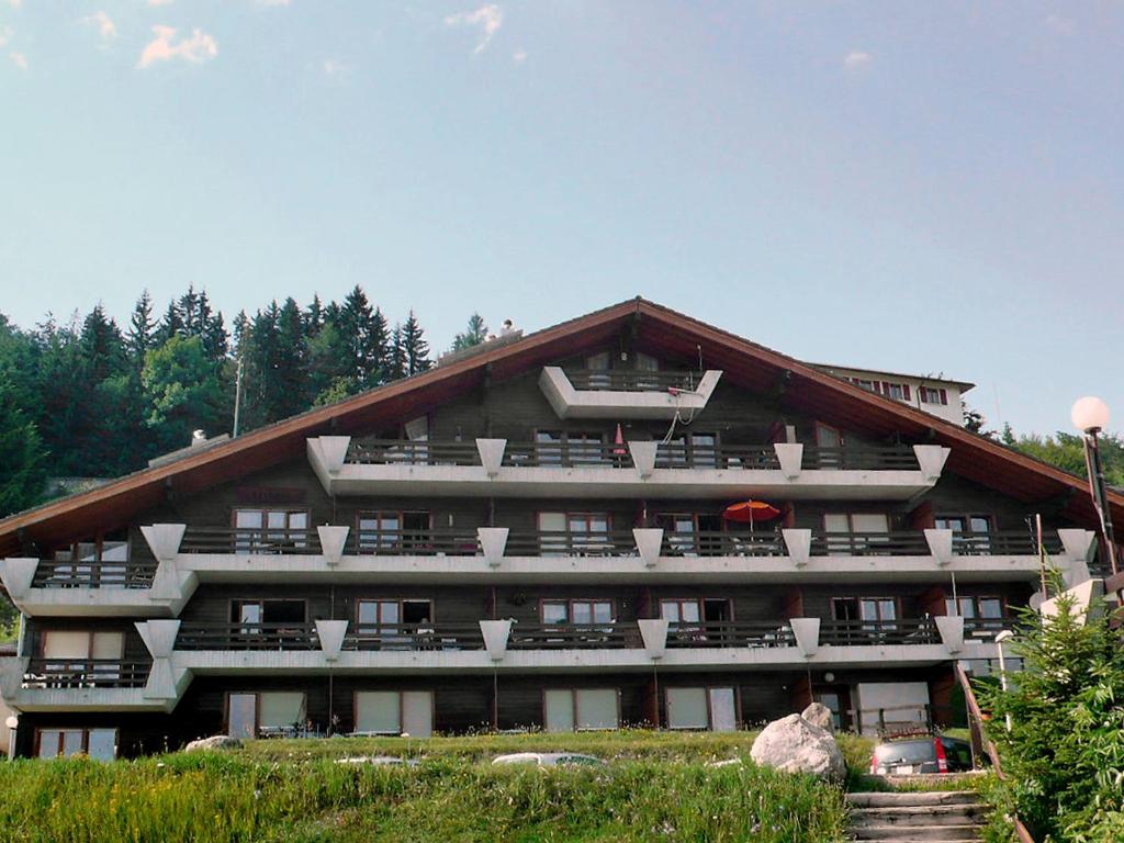 a large building with balconies on the side of it at Apartment Licorne by Interhome in Les Rasses